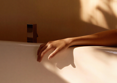 Transformation womans hand on white tub